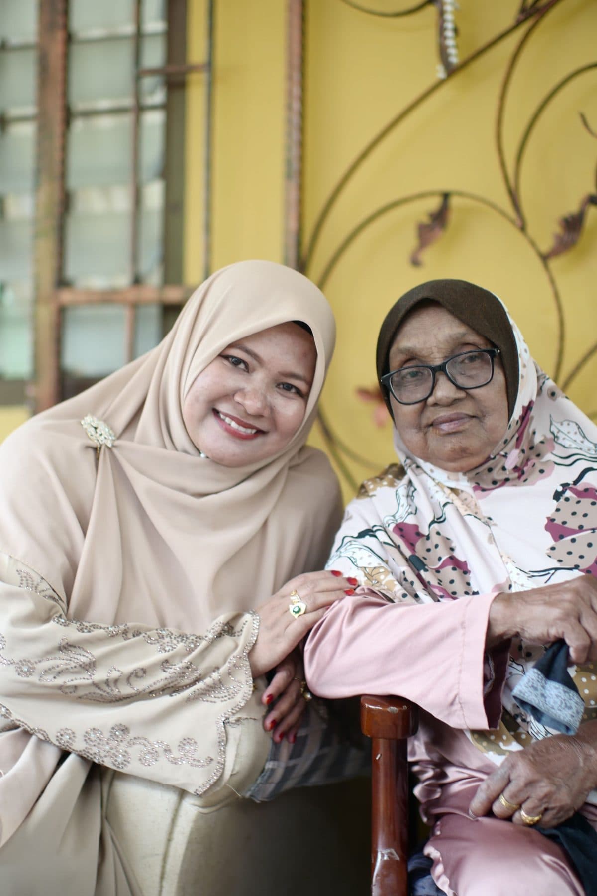 Mother and daughter smiling at home